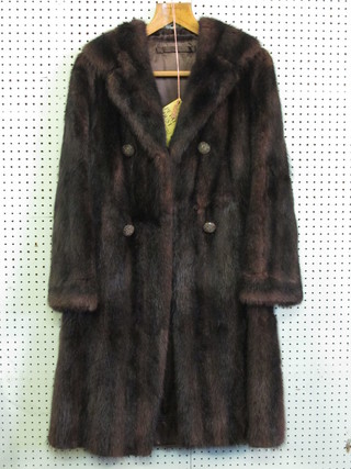 A lady's double breasted mink fur coat