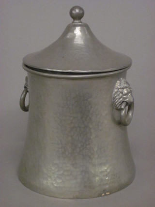 An Abbey waisted planished pewter twin handled biscuit barrell