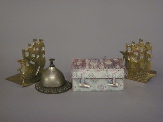 A pair of pierced brass book ends in the for of galleons, 2 turned marble balls and a table bell