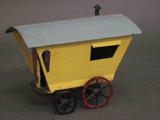 A metal painted model of a Romany caravan 8 1/2"