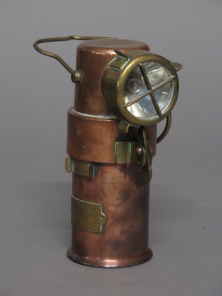 A cylindrical copper and brass safety inspection lamp by CEAG  Ltd Barnsley
