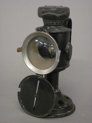 A candle powered hand lantern with black out lens cover by T E Bladon & Sons