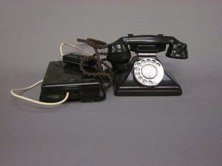 A black Bakelite dial telephone with bell box