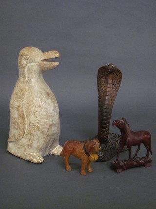 A wooden carved figure of a cobra 9", do. penguin 10" and a  horse and dog