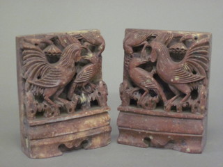 A pair of carved soap stone book ends decorated birds 6"