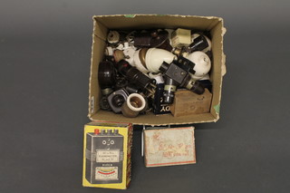 A box containing a collection of vintage ceramic, Bakelite and brass light fittings etc