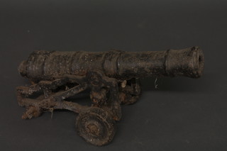 An iron Folly cannon with 14" barrel, raised on a garrison  carriage, 2 wheels missing,