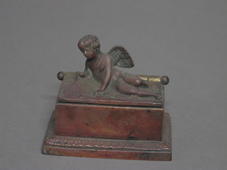 A rectangular 18th/19th Century bronze inkwell with hinged lid decorated a reclining cherub 4"