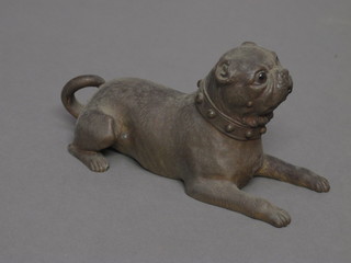 A bronze figure of a reclining pug with glass eyes 6", 1 eye  missing,