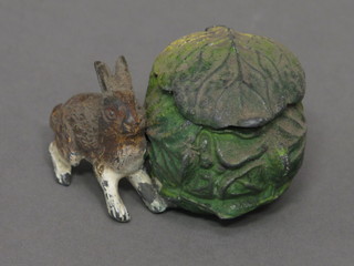 A painted metal inkwell in the form of a seated rabbit with  cabbage 2"