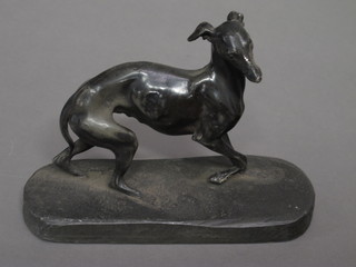 A metal figure of a greyhound, raised on an oval base 7"