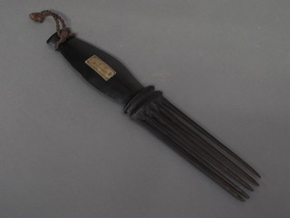 A wooden 5 pronged fork with old label marked Canibal