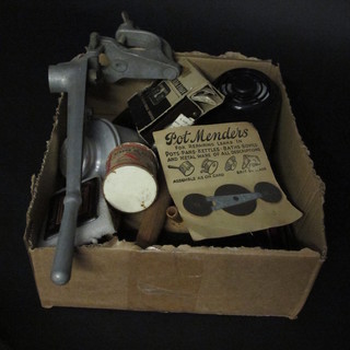 A box containing a collection of various domestic curios