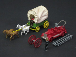 A metal model of a fire engine and a do. covered wagon