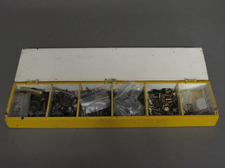 A rectangular yellow painted shallow box with hinged lid fitted various O gauge railway spares