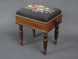 A rectangular Victorian walnut adjustable piano stool raised on  turned and fluted supports 17"