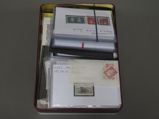 A red metal biscuit tin containing a collection of various foreign stamps