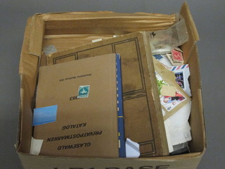 A collection of various stamps contained in a cardboard box