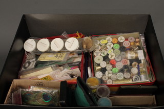 A box containing various fly tying equipment etc