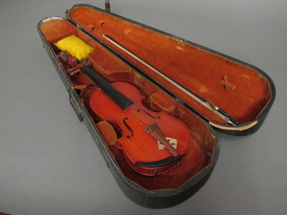 A childs violin labelled JTL, complete with bow, contained in a  wooden carrying case