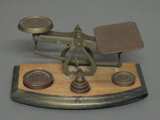 A brass letter scale complete with weights