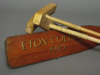 A pair of no.51 Polo mallets by J Salter & Sons of Aldershot together with a wooden paddle marked Eaton College