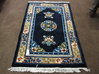 A blue ground and floral patterned Chinese rug 58" x 36"