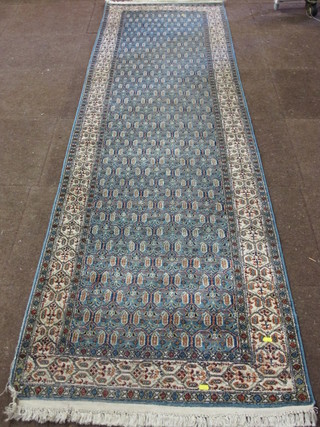 An Indian Kashmiri blue ground runner with stylised design to  the centre 114" x 31"