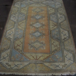 A contemporary Caucasian style rug with 5 octagons to the centre 115" x 81"