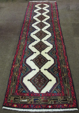 A contemporary white ground Persian carpet with 8 octagons to  the centre within a multi-row border 113" x 30"