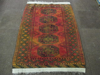 An orange ground Afghan rug with 5 octagons to the centre 60"  x 41"