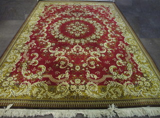 An Israeli machine made red ground and floral patterned carpet  129" x 88"