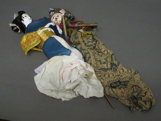 An Eastern puppet together with an Eastern dog in the form of a standing Geisha