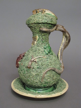 A 19th Century Majolica ewer and cover complete with stand,  having a serpent handle and decorated various animals, the base  with impressed mark, 11", some damage, lid chipped, handle  restored,  ILLUSTRATED