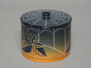 A Dennis Chinaworks limited edition cylindrical jar and cover,  designed by Sally Tuffin with spider's web decoration, the  interior signed with Spider's mark, no 23, base signed 4", from a limited run of 36 pieces.