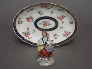 A Sevres oval boat shaped dish with blue and gilt banding and floral decoration, the reverse marked RF Sevres BA 10 1/2"  together with a Continental porcelain figure of a seated lady 4"