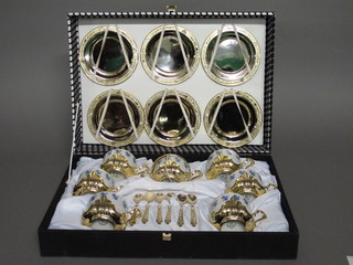 A German porcelain and gilt metal mounted 12 piece coffee  service comprising 6 coffee cups and saucers together with 6  spoons, cased
