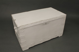 A white painted and metal bound trunk with hinged lid and iron drop handles 33"