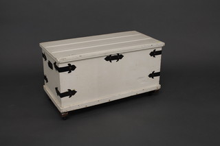A rectangular white painted pine trunk with hinged lid and iron corners 33"
