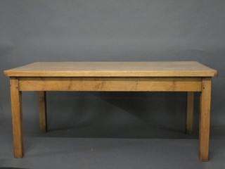 A rectangular pine kitchen table, raised on square tapering supports 66"
