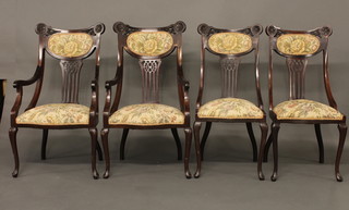 An Edwardian mahogany 4 piece drawing room suite comprising  pair of open arm chairs with pierced vase shaped slat backs and a  pair of standard chairs, raised on cabriole supports