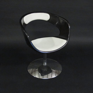 A 1960's style plastic swivel tub back chair