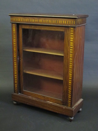 A Victorian mahogany and parquetry Pier cabinet, the shelved  interior enclosed by a glazed panelled door, raised on turned  supports 30"
