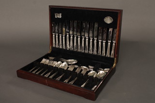 A canteen of silver plated flatware contained in a mahogany canteen