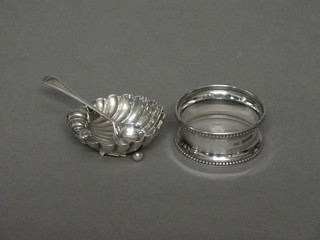 A silver napkin ring together with a small silver salt and spoon