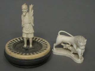 A carved ivory figure of a lion and buffalo, 3" and a carved  ivory figure of a standing gentleman