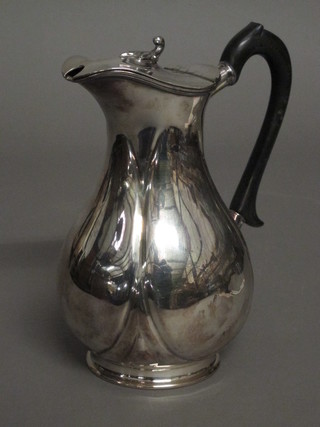 A silver plated hotwater jug of baluster form