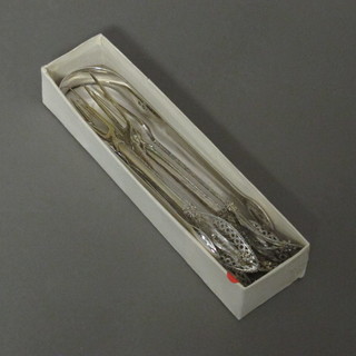 A pair of Georgian silver sugar tongs and 6 various Eastern white metal filigree forks