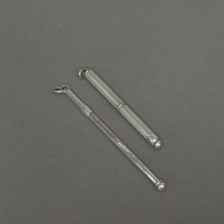 A silver swizzle stick and 1 other