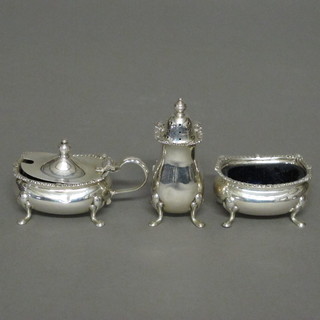 A 3 piece silver condiment set comprising mustard, salt and pepper, Birmingham 1962, complete with blue glass liners 3 ozs